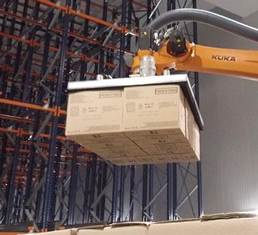 Distribution Center robotic arm moves cases