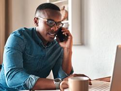 black man working from home, on phone at computer